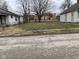 Street view of a property showing a grassy area between two homes and a vacant lot at 1924 E Maryland St, Indianapolis, IN 46201