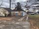View of a home with a concrete driveway, and boarded up windows at 1924 E Maryland St, Indianapolis, IN 46201