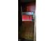 This kitchen shows damaged floors and red cabinets at 1924 E Maryland St, Indianapolis, IN 46201