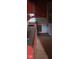 Kitchen showcases worn wood floors, red cabinetry, and a basic laundry area at 1924 E Maryland St, Indianapolis, IN 46201