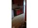 Kitchen with stained, pale wood flooring and red wooden cabinetry at 1924 E Maryland St, Indianapolis, IN 46201