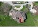 A high angle aerial view showing the house with its brick patio and surrounding lawns at 1937 Knightsbridge Rd, Danville, IN 46122