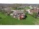 Aerial view of home showing spacious backyard with patio, lush lawns, and mature trees at 1937 Knightsbridge Rd, Danville, IN 46122