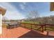 View of spacious back deck with railing overlooking landscaped yard and lake at 1937 Knightsbridge Rd, Danville, IN 46122