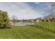Well-manicured backyard features landscaping and water views of the lake at 1937 Knightsbridge Rd, Danville, IN 46122