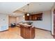 Finished basement bar area with sink, peninsula, and wood-look floors at 1937 Knightsbridge Rd, Danville, IN 46122
