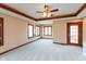 Spacious bedroom featuring multiple windows, plush carpeting, and a decorative ceiling fan at 1937 Knightsbridge Rd, Danville, IN 46122