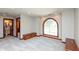 Spacious carpeted bedroom with arched window and view to a bathroom at 1937 Knightsbridge Rd, Danville, IN 46122