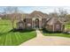 Beautiful brick home with a manicured lawn, an inviting entryway, and lush landscaping at 1937 Knightsbridge Rd, Danville, IN 46122