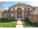 Beautiful brick home with manicured lawn and welcoming front entrance with an arched window and a grand colonnade at 1937 Knightsbridge Rd, Danville, IN 46122