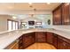 Functional kitchen with wood cabinets, a spacious countertop, and hardwood floors, complemented by natural lighting at 1937 Knightsbridge Rd, Danville, IN 46122