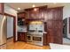 A kitchen showcasing custom wood cabinetry, a stainless steel range, and decorative backsplash tiles at 1937 Knightsbridge Rd, Danville, IN 46122