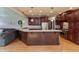 Open kitchen with dark wood island, stainless steel appliances, and connection to a cozy living area at 1937 Knightsbridge Rd, Danville, IN 46122