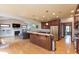 Well-appointed kitchen with wood cabinets, a center island, and hardwood floors, seamlessly connecting to the living area at 1937 Knightsbridge Rd, Danville, IN 46122