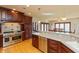 Gourmet kitchen featuring stainless steel appliances, dark wood cabinets, and a breakfast bar overlooking the dining area at 1937 Knightsbridge Rd, Danville, IN 46122