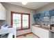 Bright laundry room with large window, white cabinetry, and modern appliances at 1937 Knightsbridge Rd, Danville, IN 46122