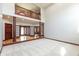 Open-concept living room with a second-story balcony, hardwood floors, and a view of the entryway, creating a grand space at 1937 Knightsbridge Rd, Danville, IN 46122