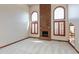 Inviting living room with soaring ceilings, a brick fireplace, and large arched windows, offering a bright and airy space at 1937 Knightsbridge Rd, Danville, IN 46122
