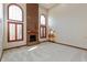 Bright living room features arched windows, a brick fireplace, and an open layout, providing ample natural light and space at 1937 Knightsbridge Rd, Danville, IN 46122