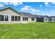 Exterior view of the backyard with green grass, patio, and vinyl siding at 19602 Atwater Ave, Sheridan, IN 46069