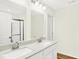 Modern bathroom featuring double sinks, quartz countertop, and a glass door shower at 19602 Atwater Ave, Sheridan, IN 46069