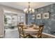 Elegant dining room with chandelier, decorative wallpaper and round table set for an intimate dinner at 19602 Atwater Ave, Sheridan, IN 46069