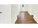 Bright hallway featuring wood flooring, white walls and trim, and a glimpse of the front door at 19602 Atwater Ave, Sheridan, IN 46069