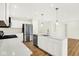 Modern kitchen with a quartz-topped island, stainless steel appliances, and wood floors, next to dining area at 19602 Atwater Ave, Sheridan, IN 46069