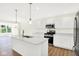 Bright, airy kitchen featuring an island with quartz countertops, stainless steel appliances and modern fixtures at 19602 Atwater Ave, Sheridan, IN 46069