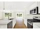 Stylish kitchen with a center island, stainless steel appliances, and white cabinets, with outside views at 19602 Atwater Ave, Sheridan, IN 46069
