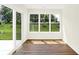 Bright sunroom featuring large windows overlooking the manicured backyard at 19602 Atwater Ave, Sheridan, IN 46069