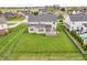 Aerial view of fenced backyard with deck showcases a well-maintained lawn and surrounding neighborhood homes at 1968 Saratoga Dr, Greenwood, IN 46143