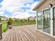 Back deck with wooden floor, black metal railings, and sliding glass door offers outdoor enjoyment and relaxation at 1968 Saratoga Dr, Greenwood, IN 46143