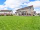Spacious backyard featuring well-maintained lawn, a small deck area and a wrought iron fence at 1968 Saratoga Dr, Greenwood, IN 46143
