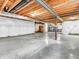 Unfinished basement featuring concrete flooring, open ceiling, and white wall coverings for storage or renovation at 1968 Saratoga Dr, Greenwood, IN 46143