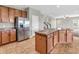 Well-lit kitchen with stainless steel appliances, a kitchen island, tile floors, and ample cabinet space at 1968 Saratoga Dr, Greenwood, IN 46143