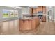 Bright eat-in kitchen featuring an island with seating, tile floors, modern appliances, and ample counter space at 1968 Saratoga Dr, Greenwood, IN 46143