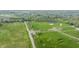 Overhead perspective of green fields, a roadway, and a water tower under a cloudy sky showcasing community amenities at 1995 W 116Th St, Carmel, IN 46032