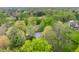 Stunning aerial view of home nestled amongst mature trees on sprawling lot at 1995 W 116Th St, Carmel, IN 46032