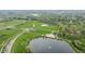 Bird's eye view with a pond featuring a fountain, a tower, and a manicured field, offering serene community views at 1995 W 116Th St, Carmel, IN 46032