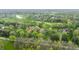 Expansive aerial shot of lush landscape featuring a golf course, lake, and beautiful homes nestled among the trees at 1995 W 116Th St, Carmel, IN 46032