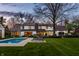 Backyard with a well-maintained pool, lounge chairs, and lush green lawn at 1995 W 116Th St, Carmel, IN 46032