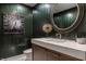 Stylish powder room with unique wallpaper, a round mirror, and a modern vanity at 1995 W 116Th St, Carmel, IN 46032