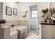 Bright bathroom featuring a soaking tub with decoratively tiled walls and modern fixtures at 1995 W 116Th St, Carmel, IN 46032