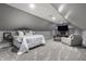 Neutral bedroom with plush bed, armchair and entertainment center with television at 1995 W 116Th St, Carmel, IN 46032
