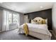 Bright bedroom featuring a queen sized bed, grey carpeting, and a view to the backyard at 1995 W 116Th St, Carmel, IN 46032
