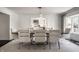 Modern dining area with seating for twelve and an adjacent, bright kitchen at 1995 W 116Th St, Carmel, IN 46032