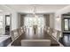 Elegant dining room with a long table, modern lighting, and bright windows at 1995 W 116Th St, Carmel, IN 46032