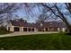 An impressive home featuring stone accents, multiple garage spaces, and a wide driveway and lush lawn at 1995 W 116Th St, Carmel, IN 46032