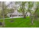 Exterior view of home with long drive and mature trees at 1995 W 116Th St, Carmel, IN 46032